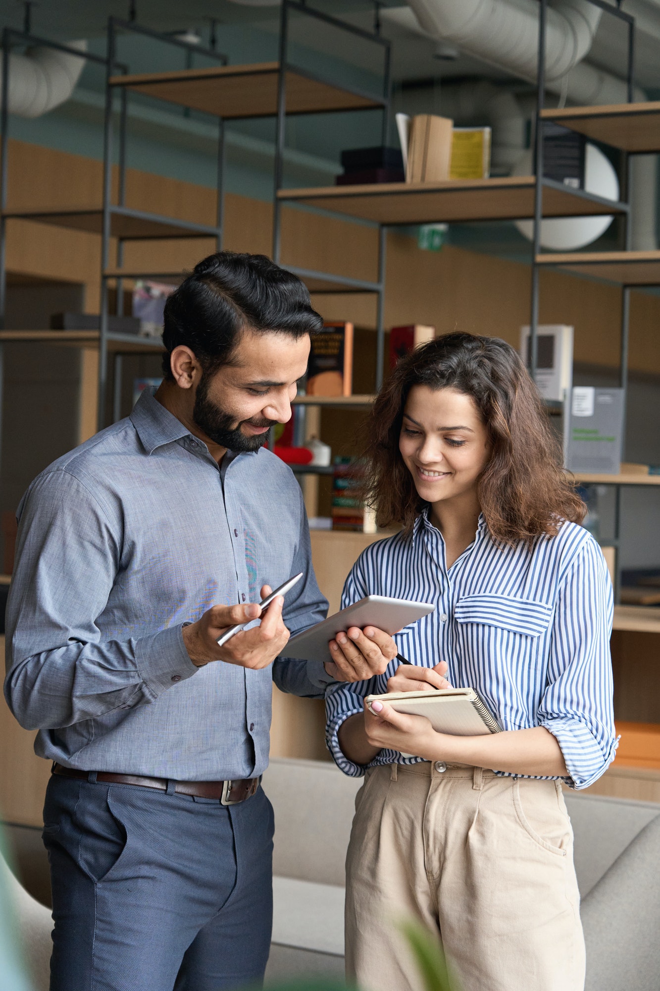 diverse-friendly-coworkers-talking-using-digital-tablet-in-office-.jpg